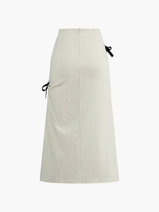 White Midi Skirt with Black Bows and Pleated Details – Elegant & Feminine